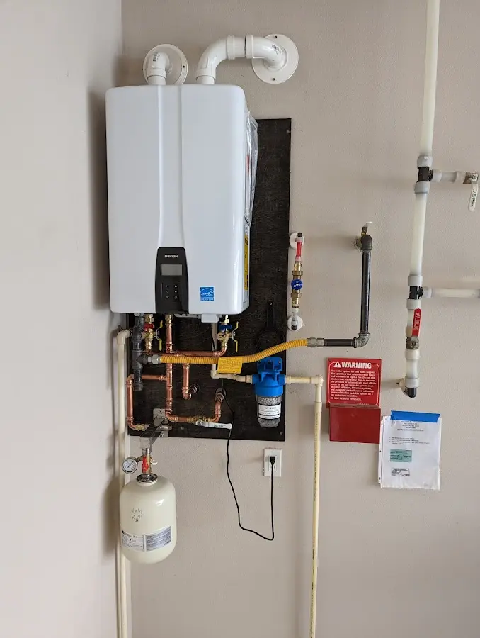 Professional plumber installing copper piping in a Cooper home